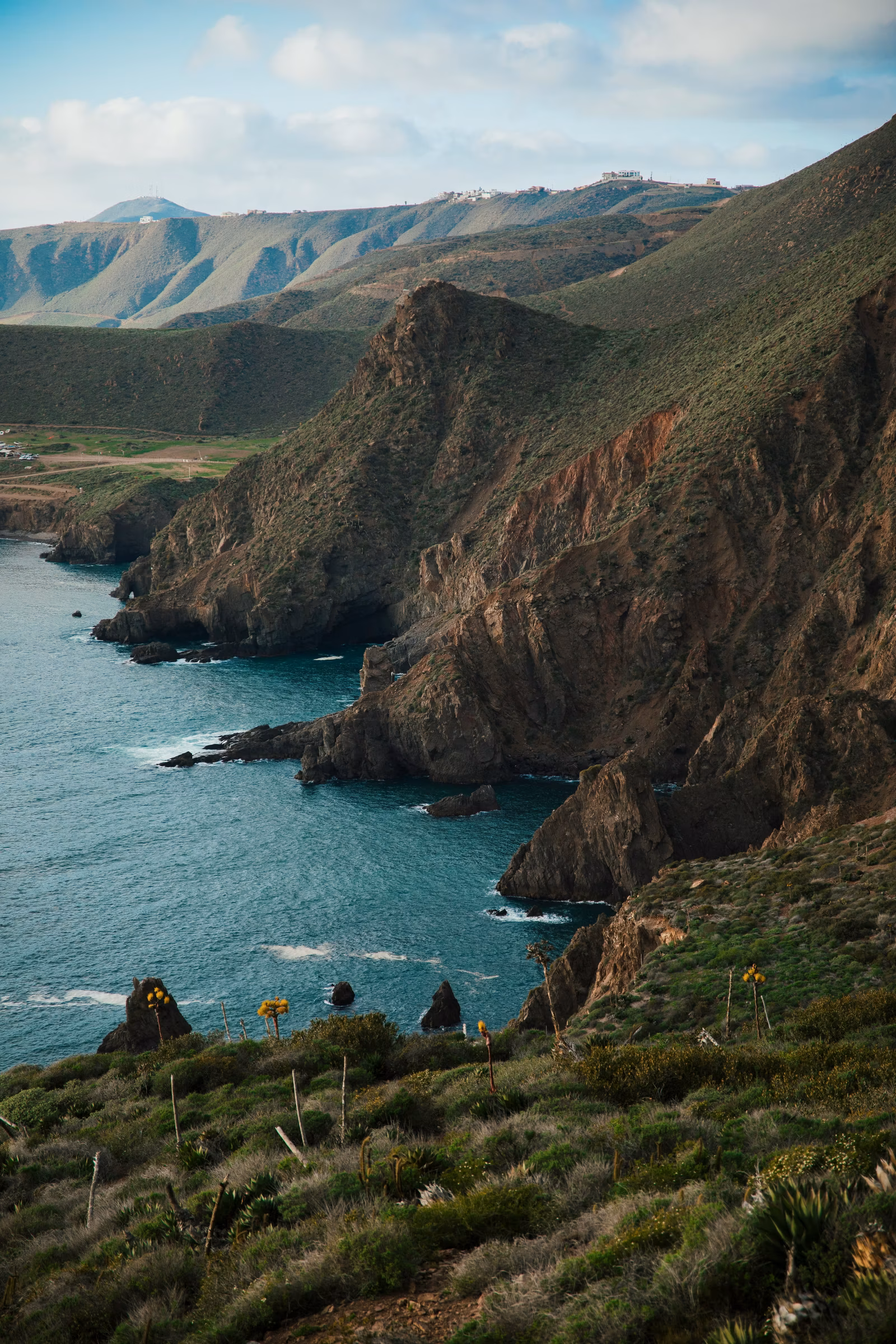 Rocky Baja California coastal cliffs descending to the deep blue Pacific Ocean, Mexico