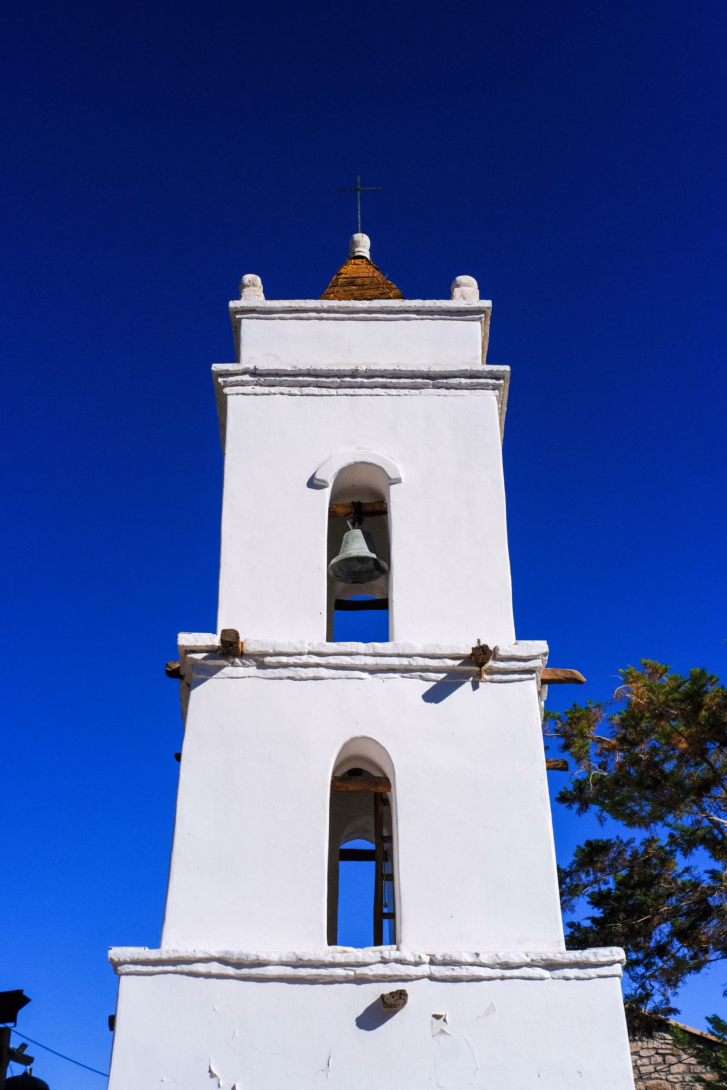 White mission church bell tower rising against a blue sky in San José del Cabo, Baja California Sur, Mexico