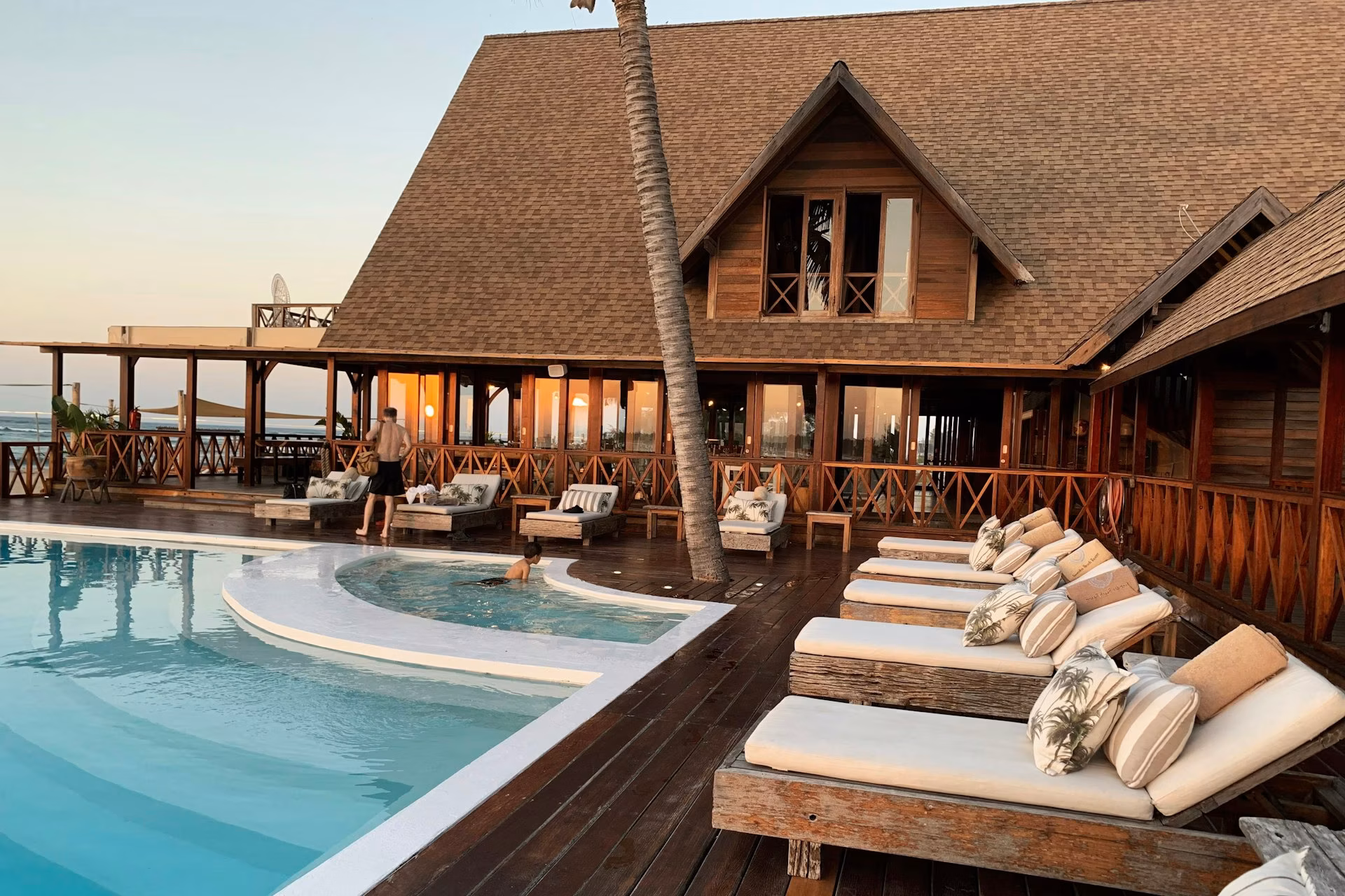 Infinity-edge pool with ocean views at golden hour, luxury residential amenity, Los Cabos