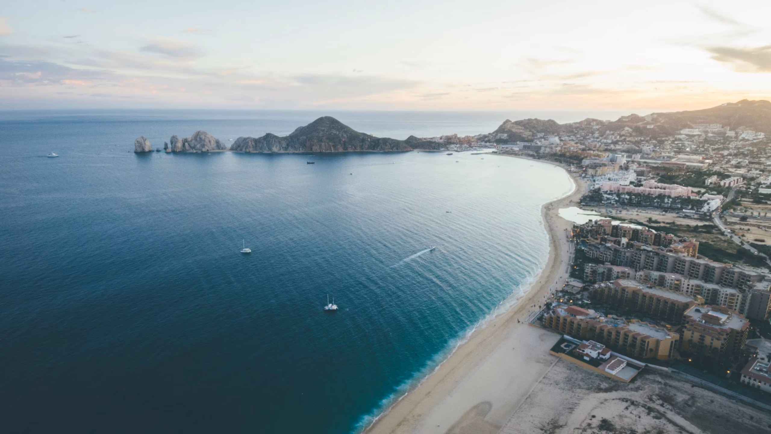 Hillside terrace pool overlooking a bay and city at sunset, Cresta del Mar lifestyle, Cabo San Lucas, Los Cabos