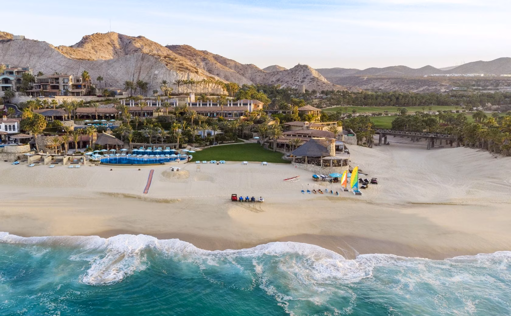 Aerial view of a private coastal golf community with manicured fairways meeting the Sea of Cortez, El Dorado, Los Cabos